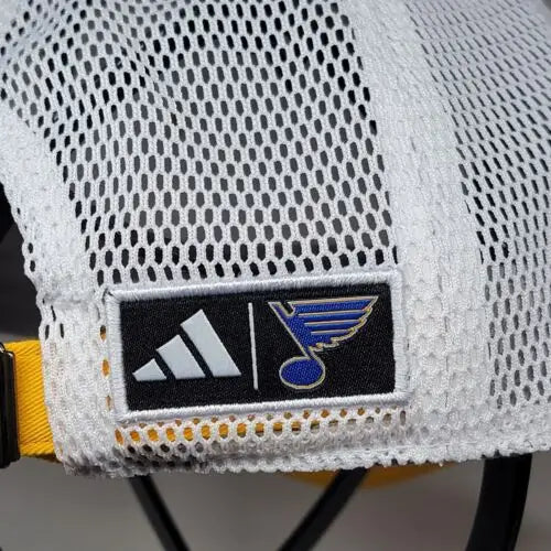 White mesh trucker hat featuring Adidas and Blues Mascot Louie logos for NHL fans