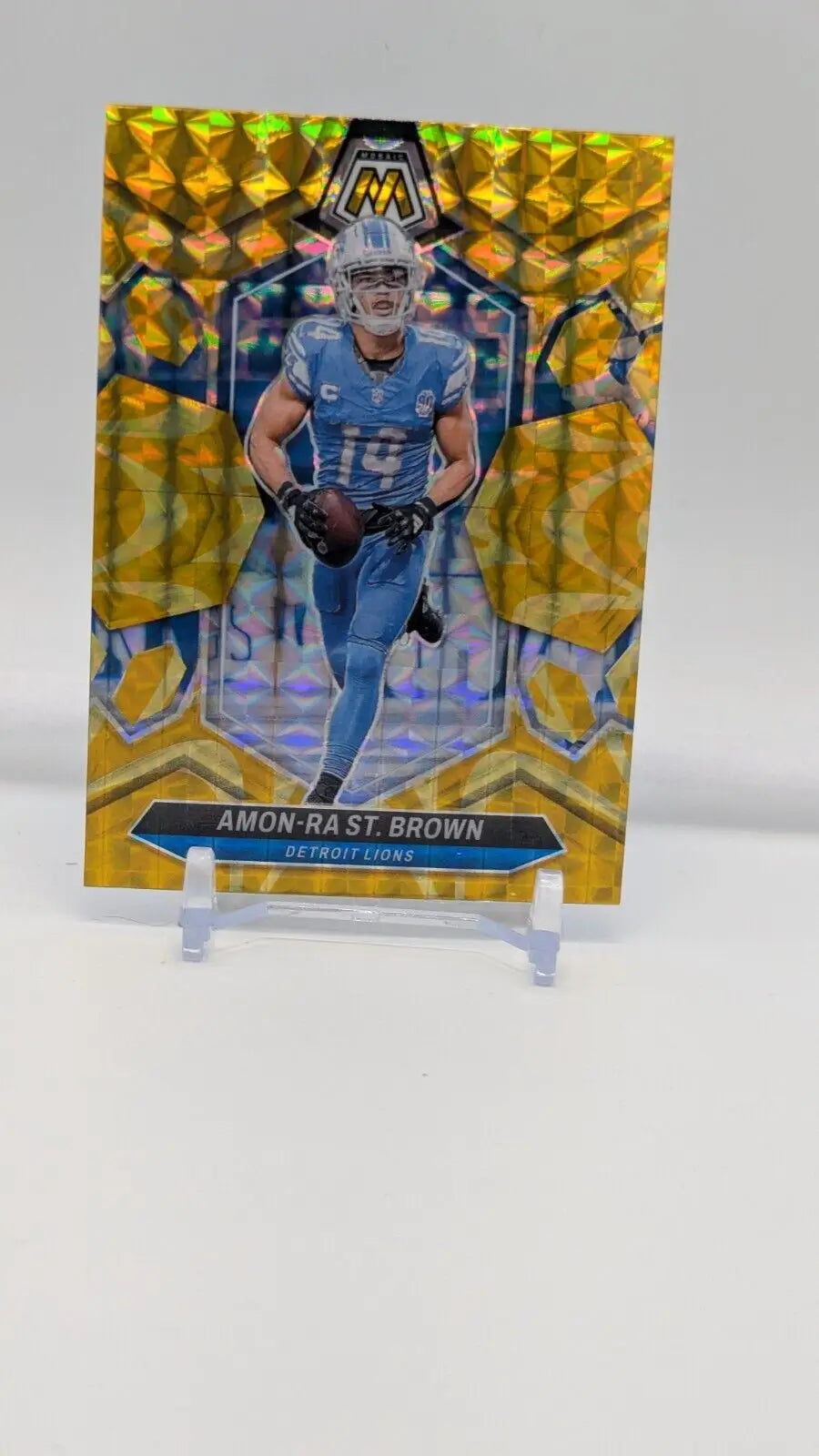 Amon-Ra St. Brown 2024 Panini Mosaic Reactive Yellow Prizm football card from Lions