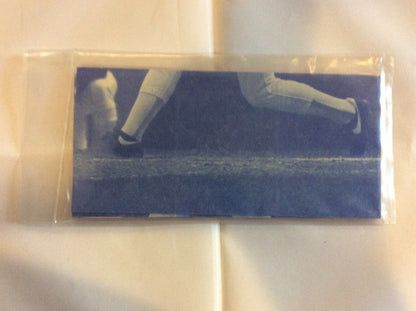 Person’s legs and feet running on blue surface featuring Wade Boggs Boston Red Sox card set