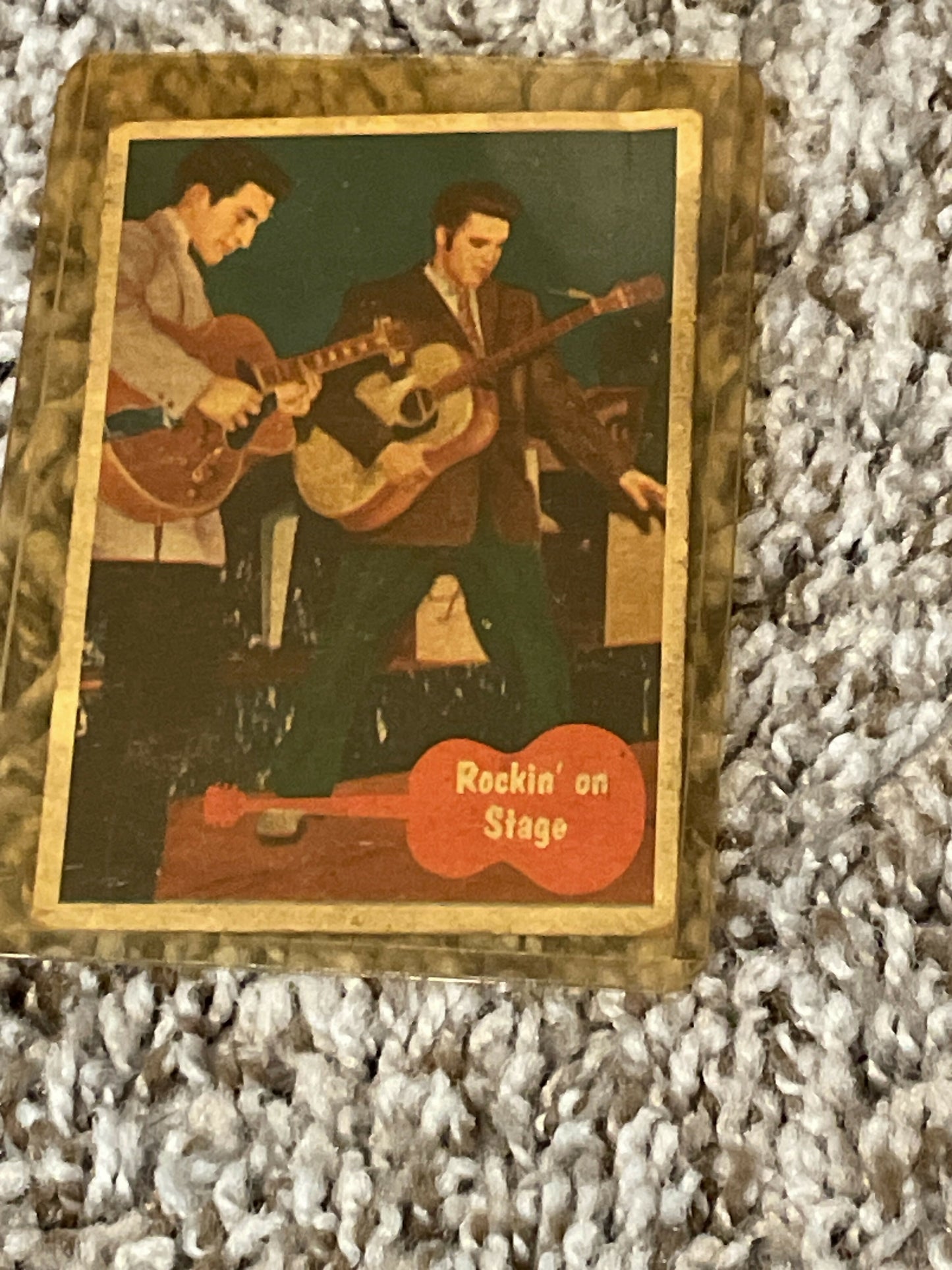 Vintage trading card of Elvis Presley performing on stage with guitars