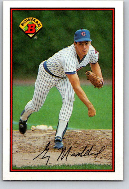 Greg Maddux pitching in Chicago Cubs pinstripe uniform, featured on baseball card