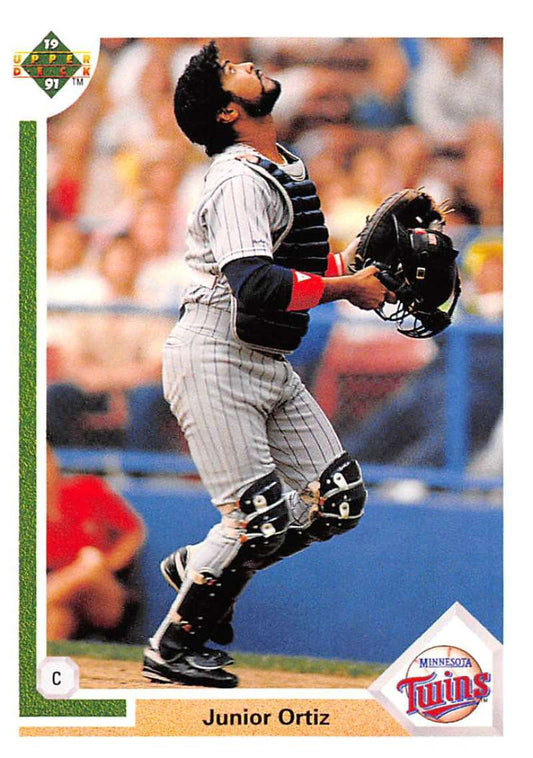 Baseball catcher Junior Ortiz in Minnesota Twins uniform catching a pop-up on Upper Deck card