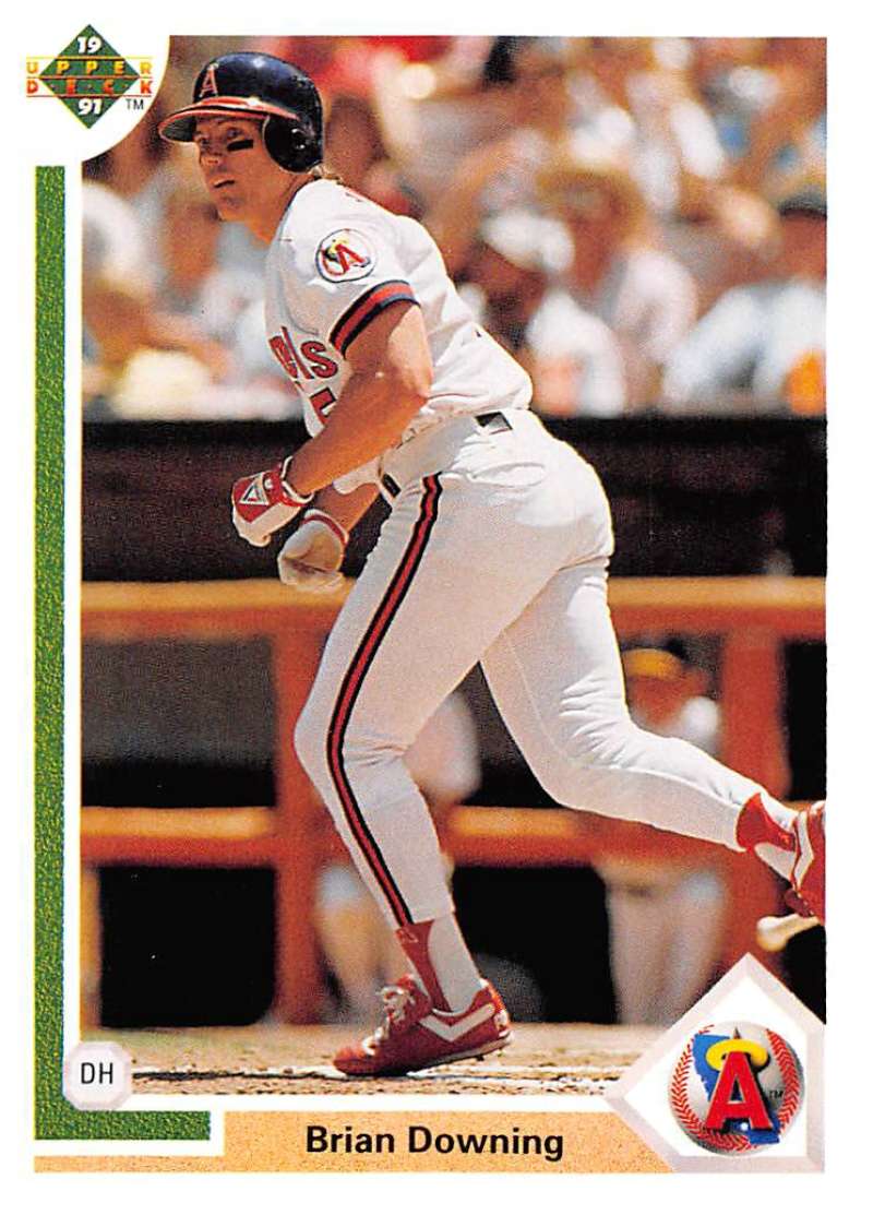 Baseball player Brian Downing in California Angels uniform swinging bat at home plate