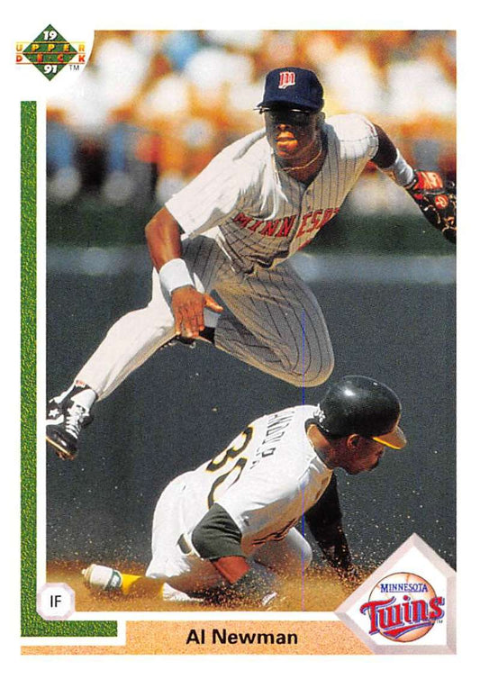 Minnesota Twins player leaps over sliding baserunner in action from baseball card