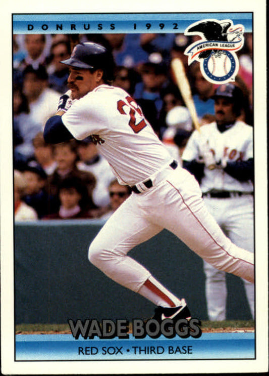 Baseball player in Red Sox uniform swinging bat on Wade Boggs AS card