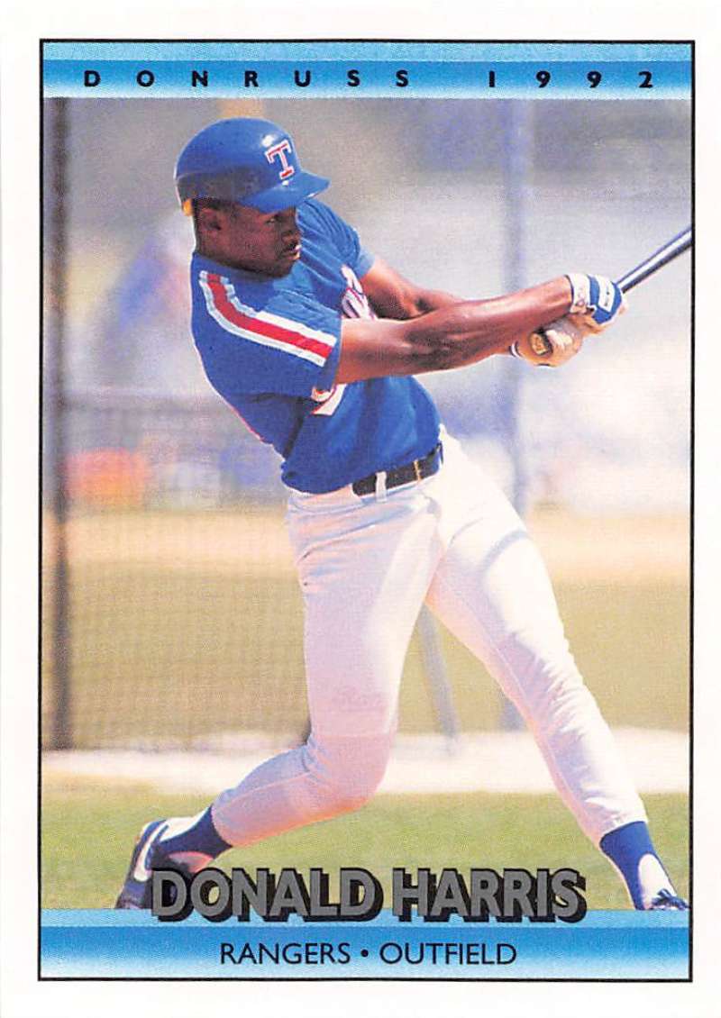 Baseball player in Texas Rangers uniform swinging bat on Donald Harris baseball card