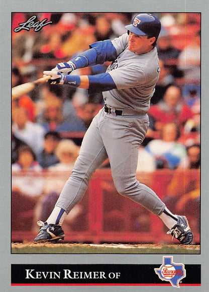 Baseball card of Kevin Reimer swinging for the Texas Rangers in a gray road uniform