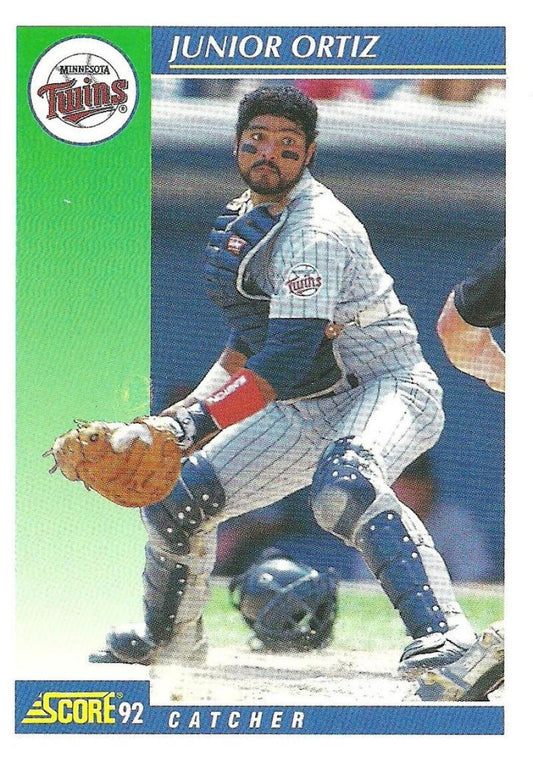 Minnesota Twins Junior Ortiz baseball card showing the catcher in action at home plate