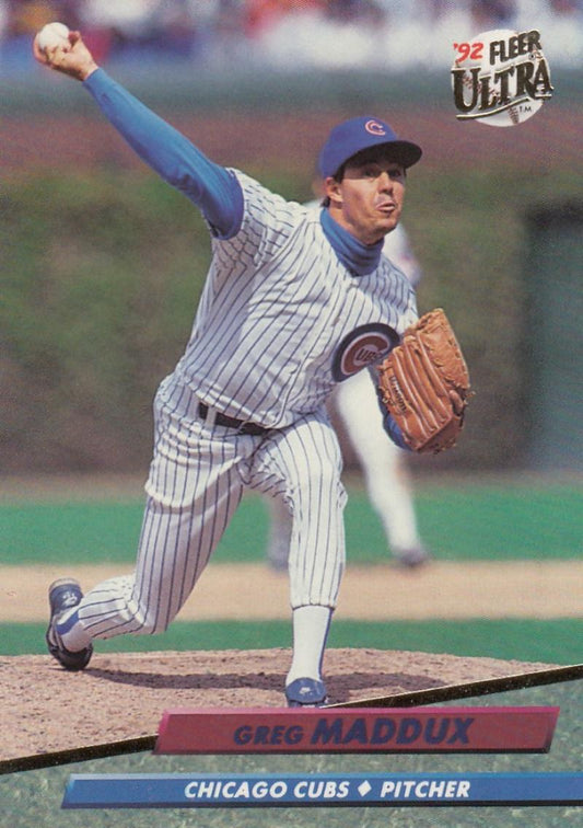 Greg Maddux delivering pitch on mound in Chicago Cubs pinstripe uniform baseball card