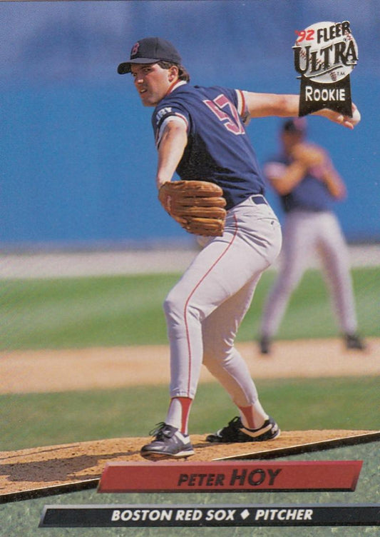 Baseball pitcher in Boston Red Sox uniform mid-delivery on the mound