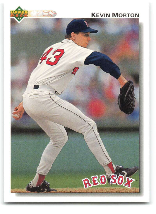 Baseball player Kevin Morton in a white Red Sox uniform mid-pitching motion