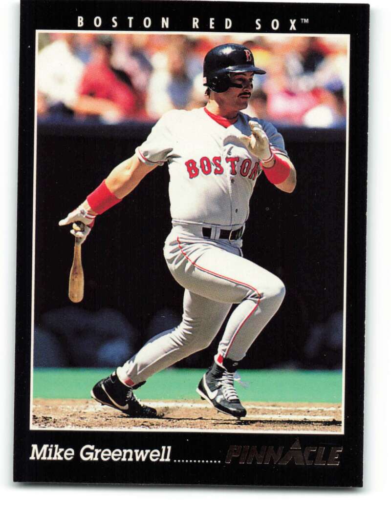 Boston Red Sox player Mike Greenwell swinging a bat in white home uniform