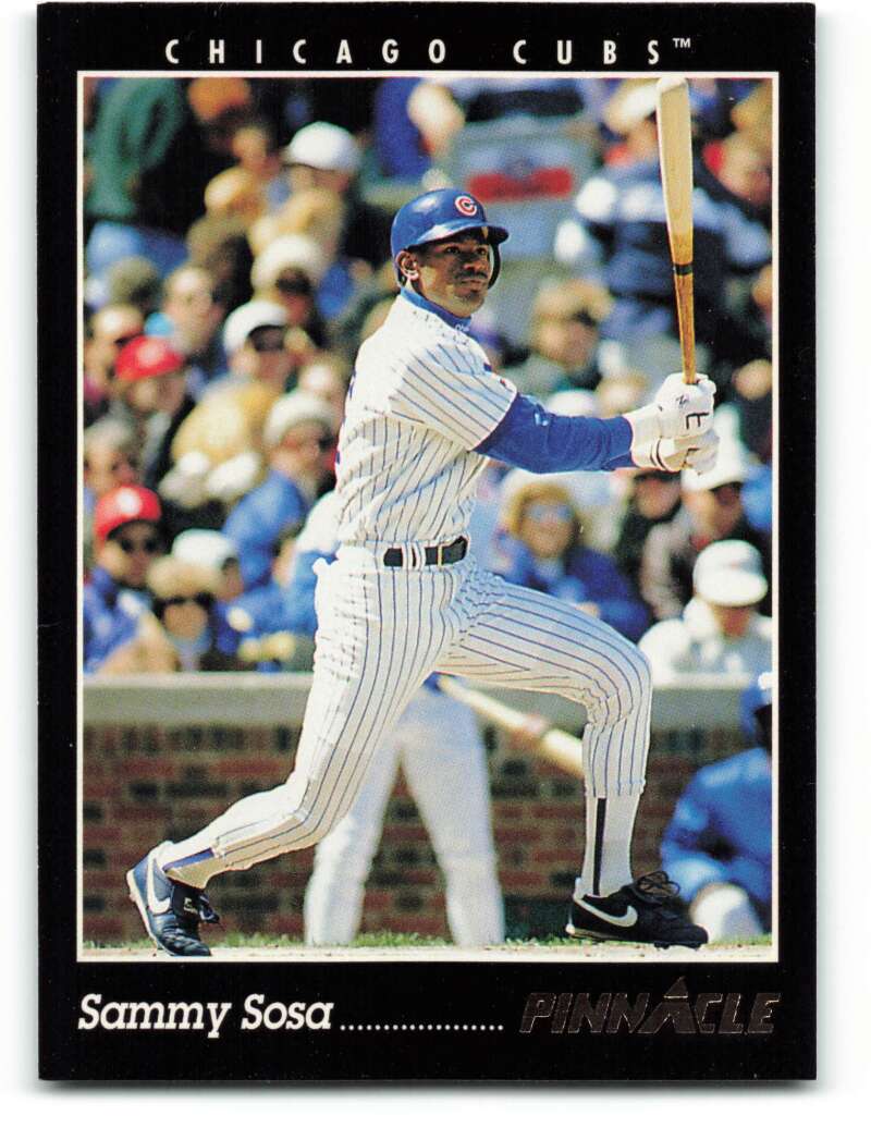 Sammy Sosa swings a bat in pinstriped uniform for a Chicago Cubs baseball card