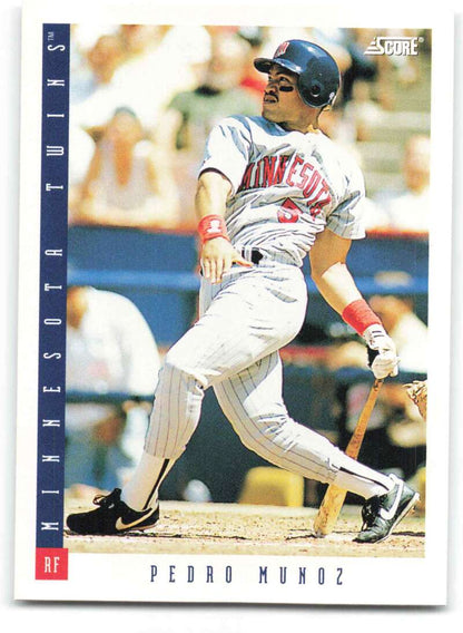 Baseball card of Pedro Munoz in a pinstriped Minnesota Twins uniform at bat