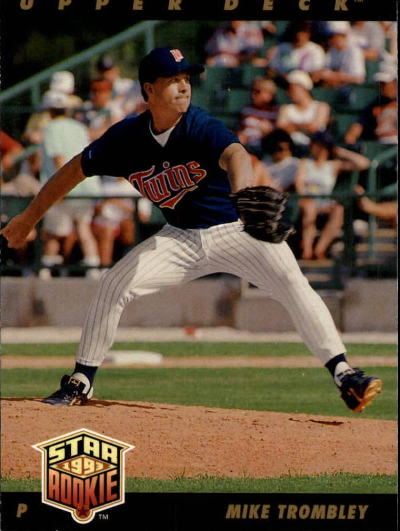 Minnesota Twins pitcher Mike Trombley mid-delivery in navy uniform baseball card image