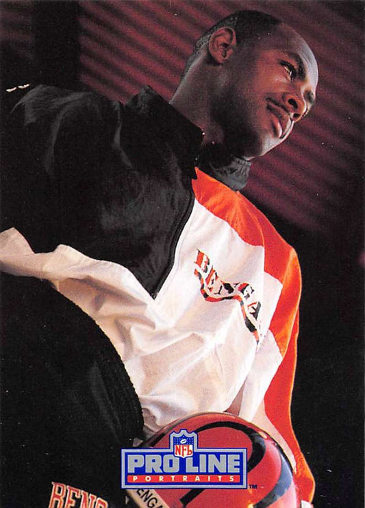 Person smiling in a black and orange NFL Pro Line jacket with James Brooks Football Card