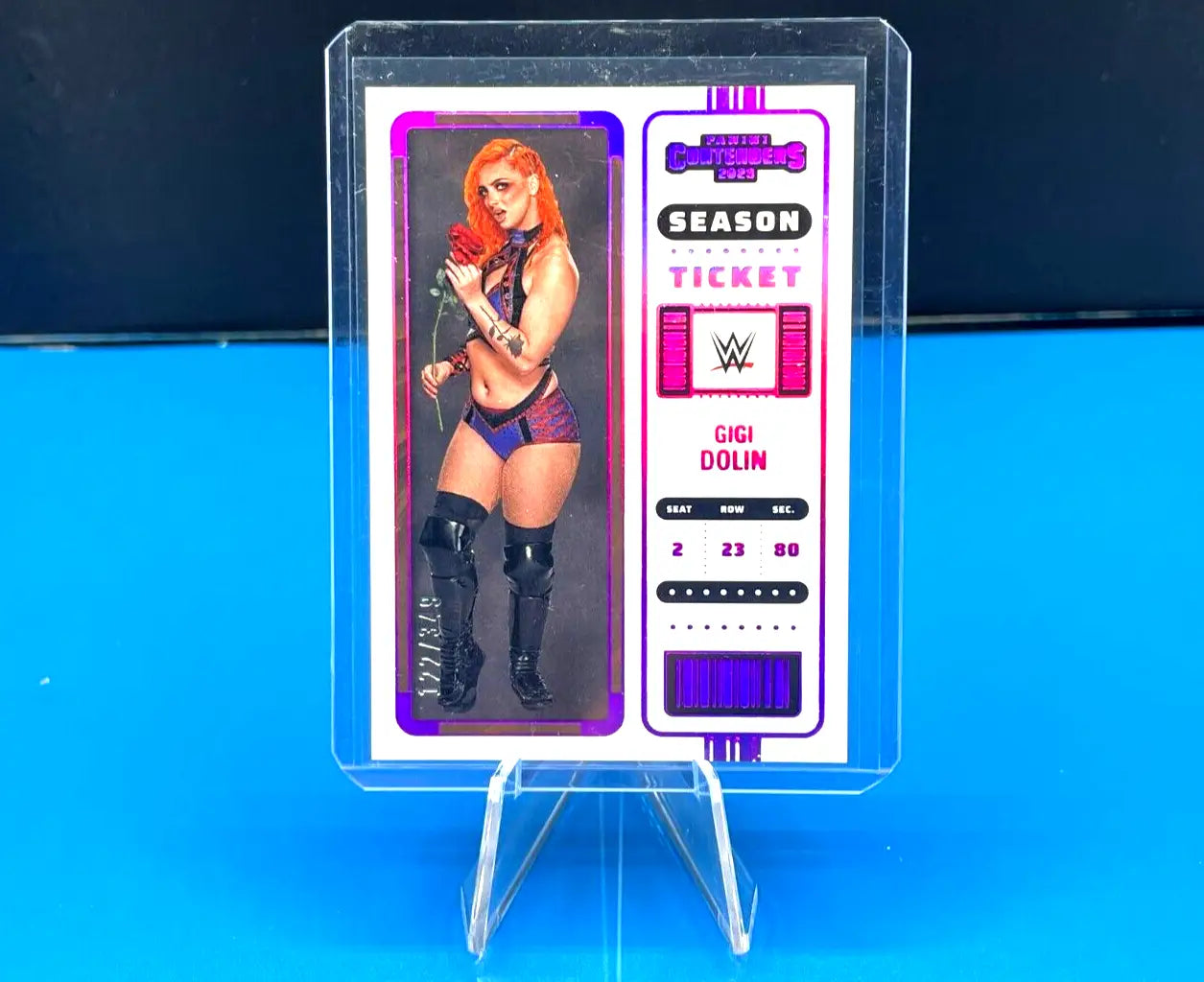 WWE trading card of Gigi Dolin in protective case, showcasing Pink Parallel variety