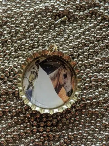 Bottle cap pendant featuring a horse photograph on an adjustable ball necklace