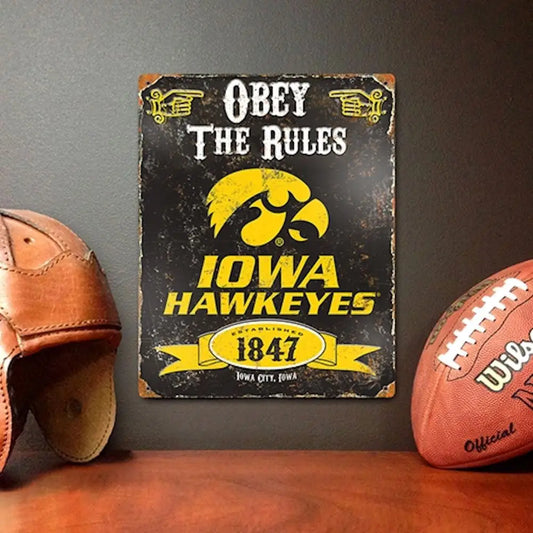 Vintage Iowa Hawkeyes embossed metal sign featuring logo and Obey the Rules text