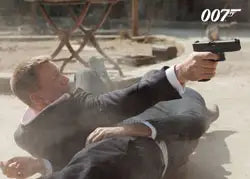 Man in a suit aiming handgun on ground for James Bond Autographs & Relics promo card