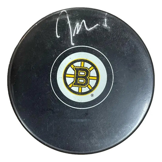 Signed black hockey puck with Boston Bruins logo by Jeremy Swayman for collectors