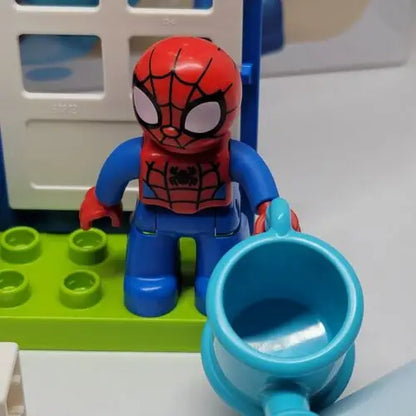 LEGO DUPLO Spider-Man minifigure beside a blue cup from Spider-Man’s House LEGO set