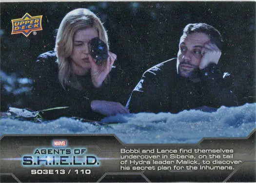 Trading card of two people in snow, one aiming a gun from Marvel Agents of SHIELD