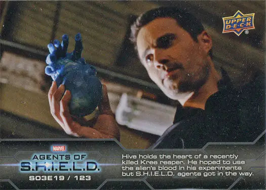 Man holding glowing blue object in Marvel Agents of SHIELD chase card image