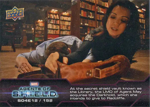 Woman with dark hair on library floor reaching for something in Marvel Agents of SHIELD chase card