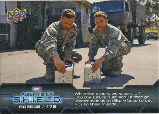 Two military personnel in camouflage examining devices on Marvel Agents of SHIELD chase card