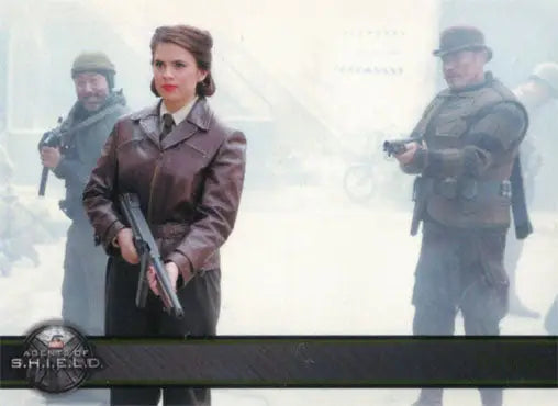 Woman in a brown coat with gun, flanked by armed men in Marvel Agents of SHIELD Gold Parallel trading card