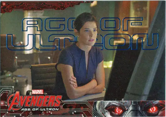 Woman in blue shirt at computer workstation with Marvel Avengers Blue Foil trading cards