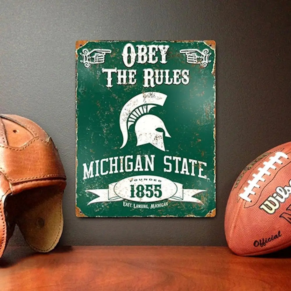 Vintage Michigan State Spartans embossed metal sign featuring Spartan logo and Obey the Rules text