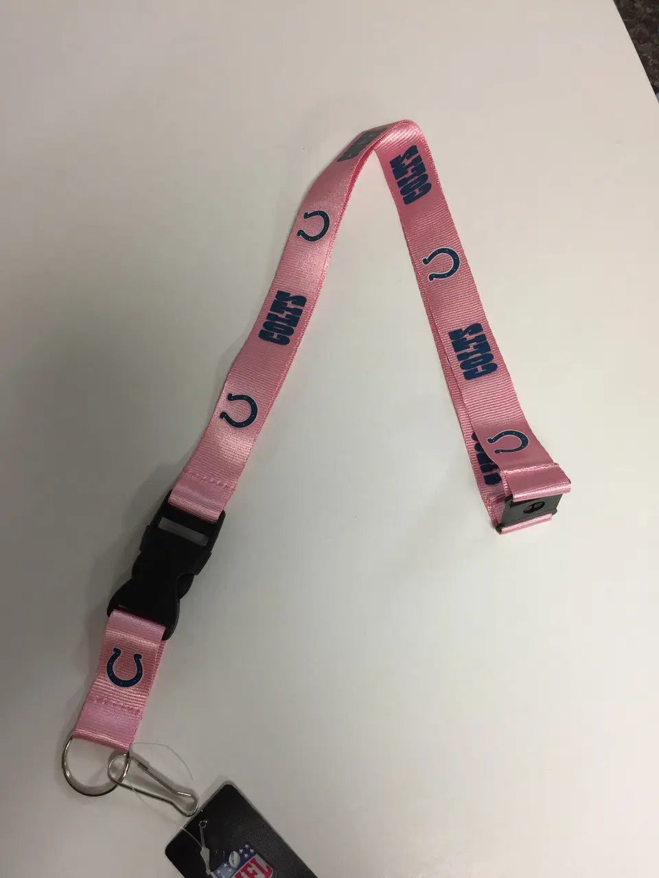 Pink lanyard with horseshoe and LUCKY text, perfect for NFL trading cards and events