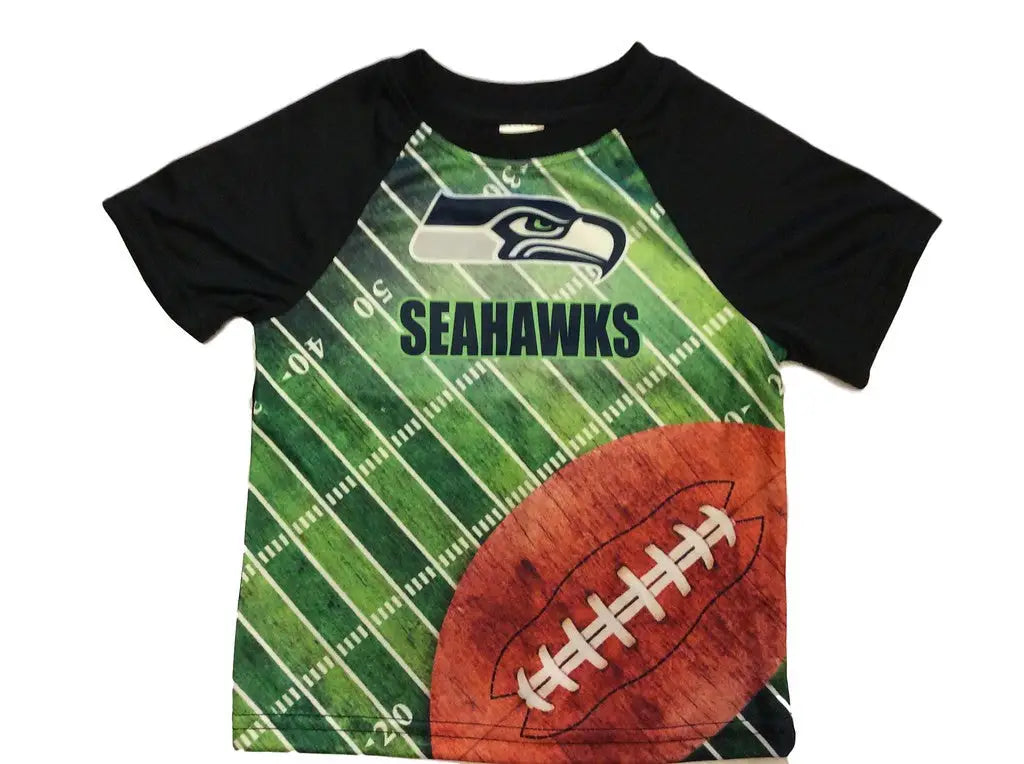 Seahawks Kids Field Tee featuring a football graphic and field pattern design