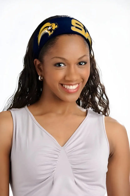 Smiling woman in white sleeveless top and blue NHL head band with yellow logos