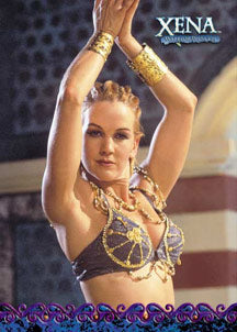 Woman in warrior costume with raised arms featured on Xena Season 6 trading card