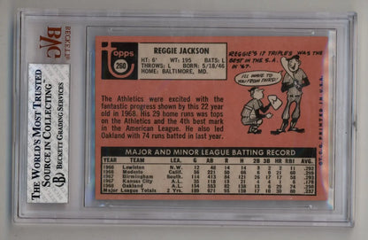 Pink vintage Reggie Jackson baseball card with statistics in protective holder