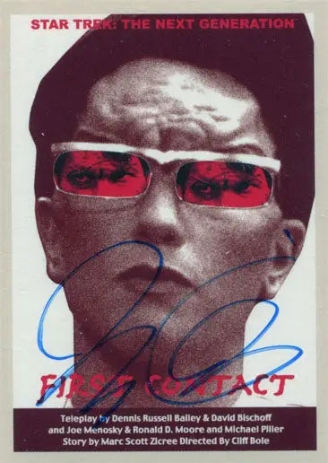 Close-up of person in red-tinted glasses with Juan Ortiz autograph on Star Trek card