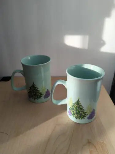 Two light blue mugs with Christmas tree design from the Holiday Christmas Collection