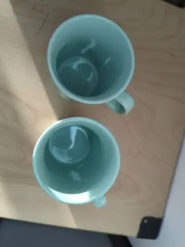 Two light blue coffee mugs from the Starbucks Holiday Christmas Collection set