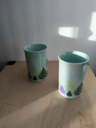 Light blue ceramic mugs with tree designs from Starbucks Holiday Christmas Collection