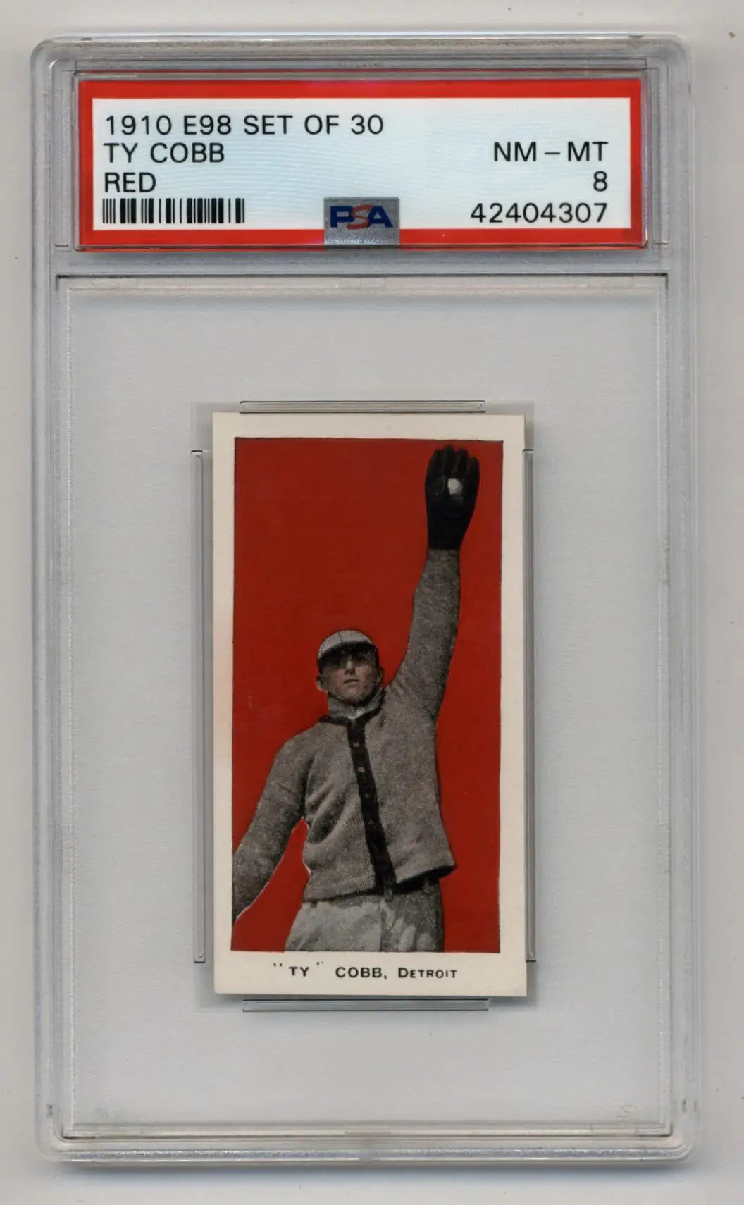 PSA-graded 1910 E98 baseball card of Ty Cobb in Detroit uniform against red background