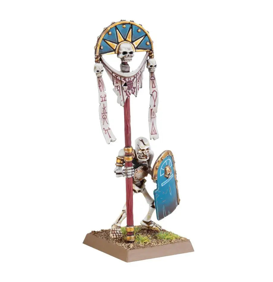 Skeleton warrior figurine under a skull banner from Warhammer Tomb Kings of Khemri