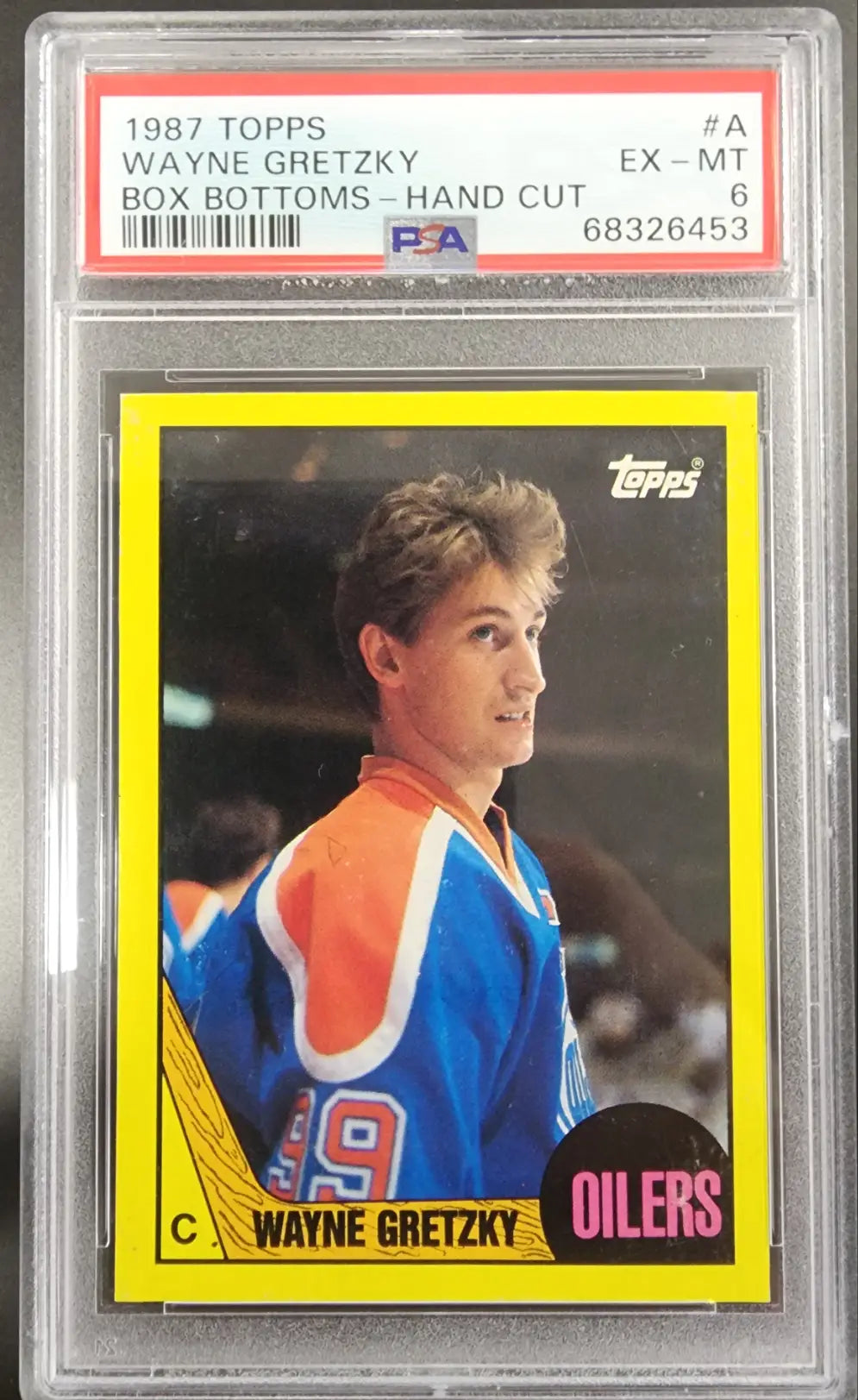 PSA-graded 1987 Topps Wayne Gretzky Oilers hockey card in protective case for sale