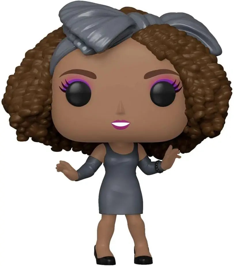 Whitney Houston Funko Pop figure in a gray dress with curly brown hair and pink eyeshadow