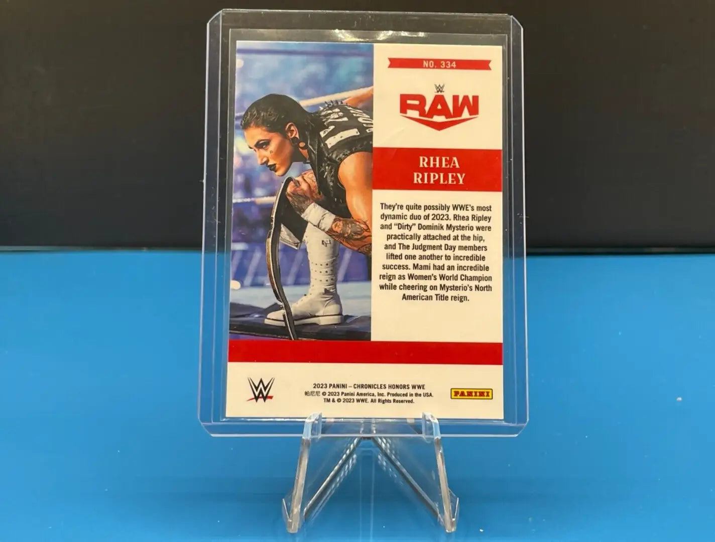 WWE 2023 Panini Chronicles Rhea Ripley Panini Honors card in protective case display