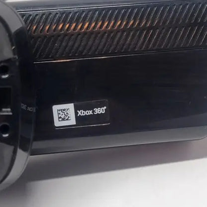 Black Xbox 360 console with logo and vents, featuring Kinect Sensor Bar compatibility